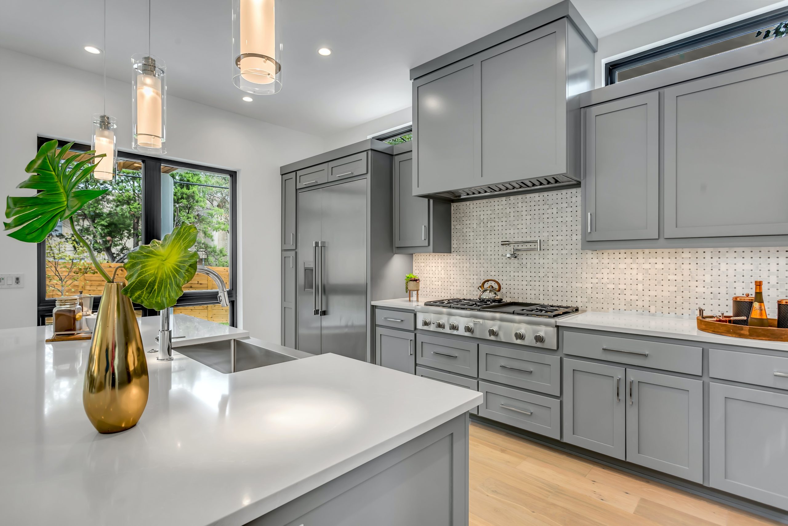 light gray kitchen cabinet with white appliances